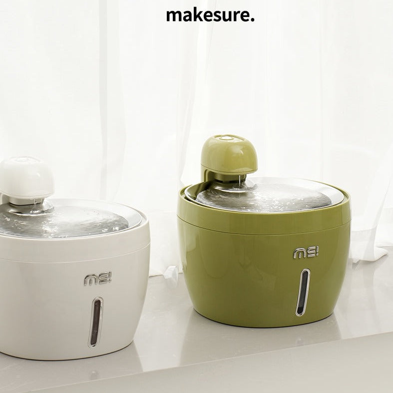 The makesure Wireless Pet Water Fountain -green and white by the window